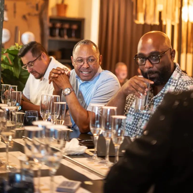 Guests laughing together at the bar