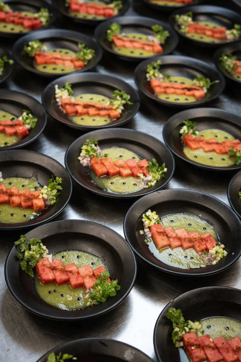 Rows of plates being finished for a dinner
