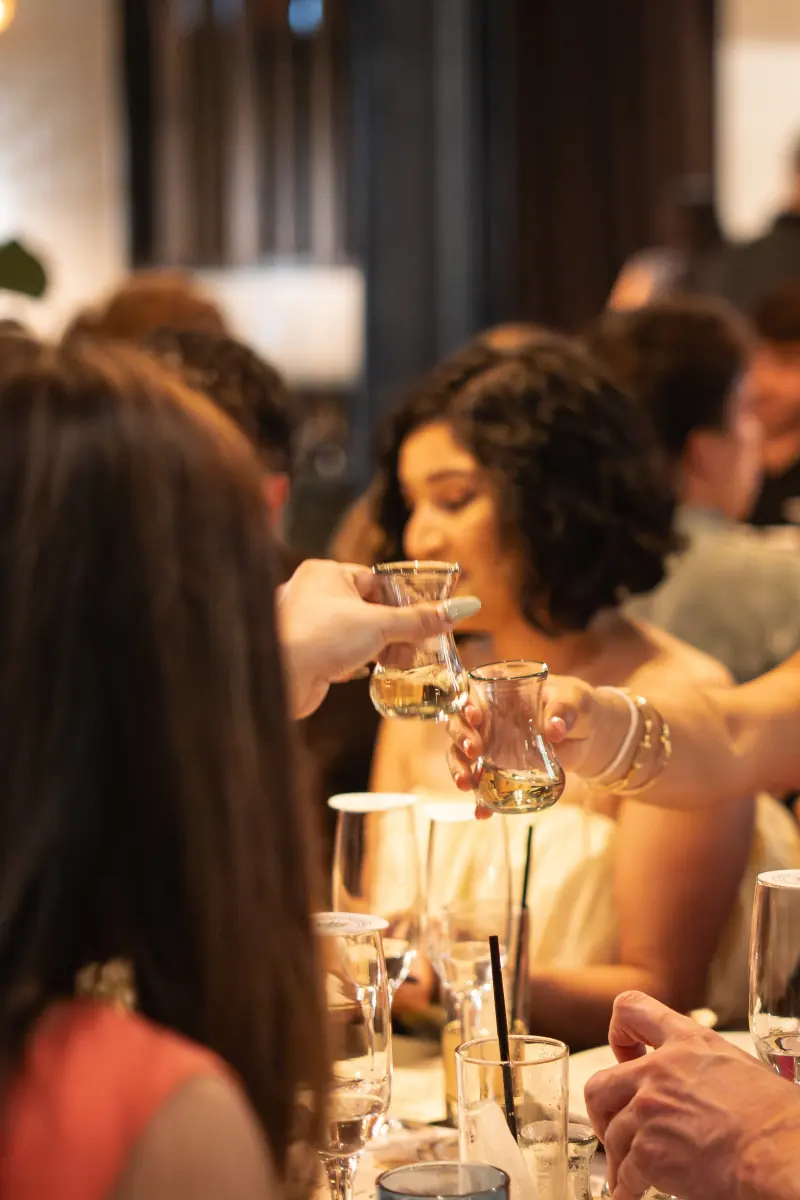 Guests raising copitas at a tasting